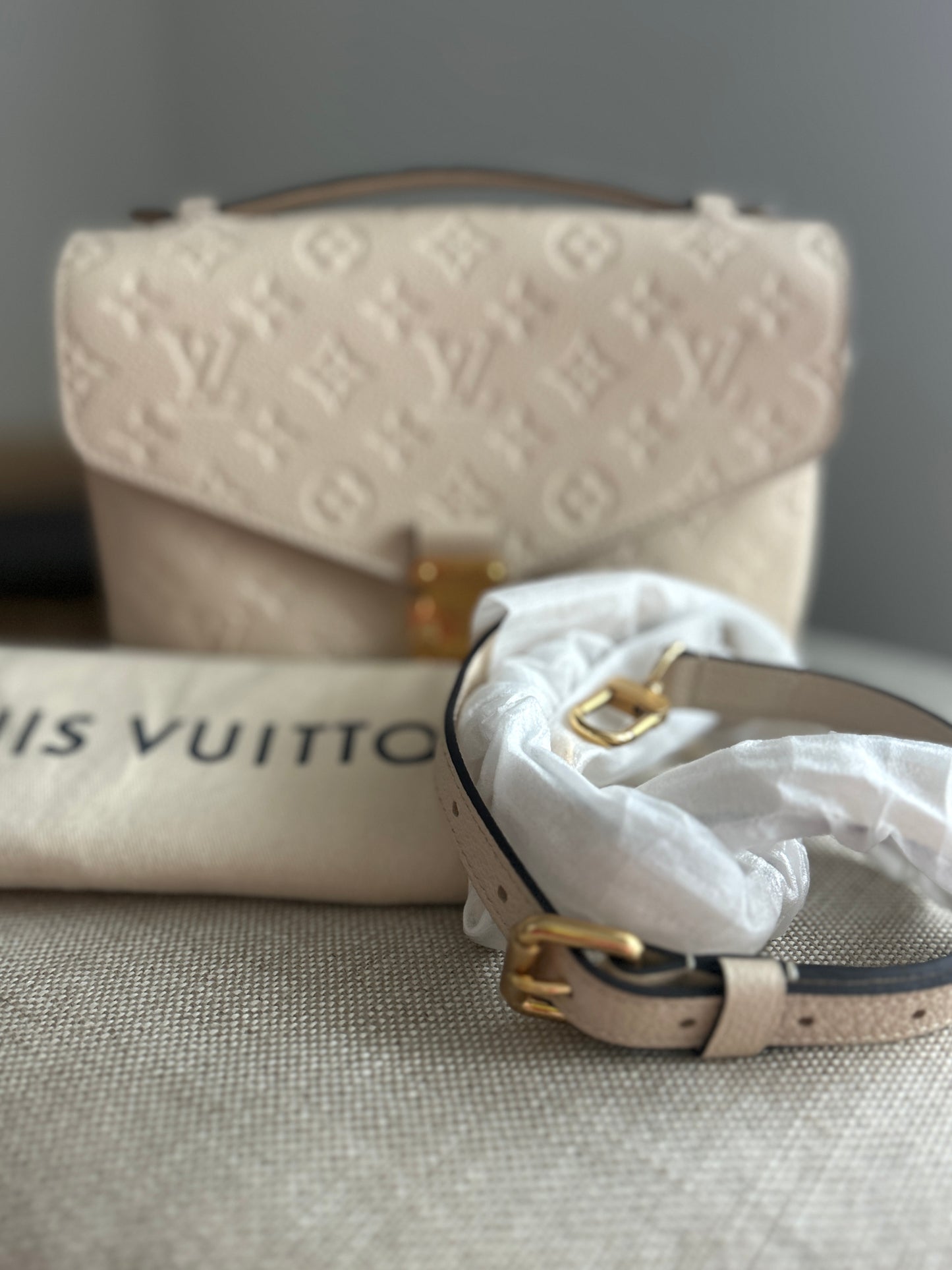 Louis Vuitton Pochette Metis Empreinte Leather in Cream