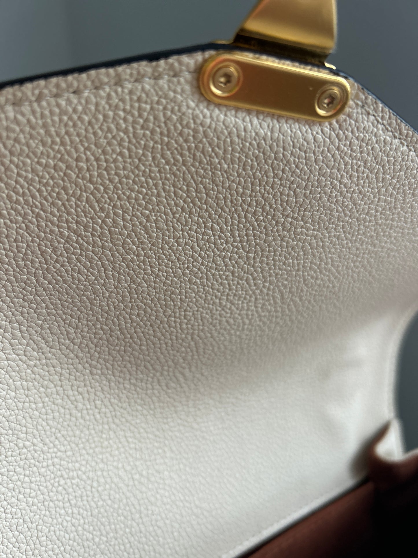 Louis Vuitton Pochette Metis Empreinte Leather in Cream